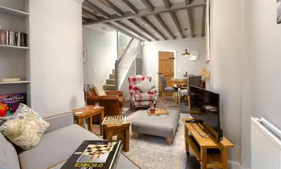 a living room with a couch and a table at Little Leveret Cottage in Keswick
