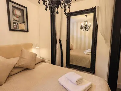 a bedroom with a bed and a large mirror at Le Chalet in Elterwater