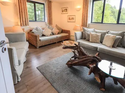 a living room with two couches and a table at Le Chalet in Elterwater