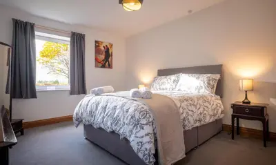 a bedroom with a bed with two towels on it at Sherriff in Penrith