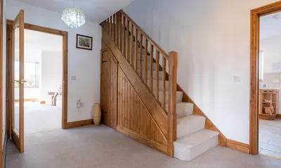a staircase in a home with a wooden door at Sherriff in Penrith