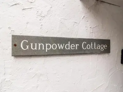a sign on a wall that reads gunpowder cartridge at Gunpowder Cottage in Elterwater
