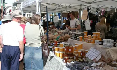a group of people standing at a farmers market at Artists Hideaway in Portinscale