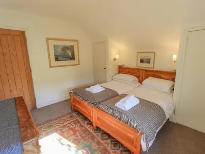 a bedroom with two beds with towels on them at Croft in Grasmere