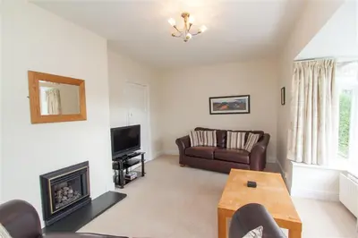 a living room with a couch and a fireplace at The Haven in Keswick