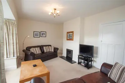a living room with a couch and a television at The Haven in Keswick