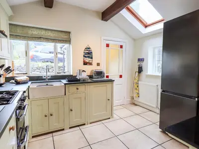 a kitchen with a sink and a stove at Holmdale in Ambleside
