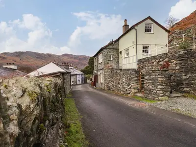 an old stone building on the side of a road at Underfell in Ambleside