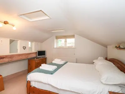 a bedroom with two beds and a television in it at Underfell in Ambleside