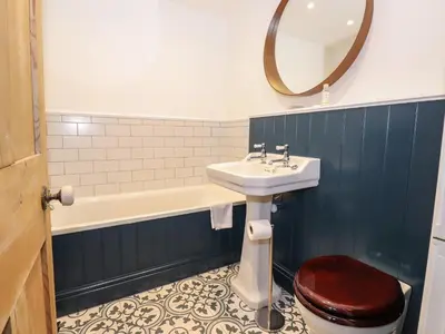 a bathroom with a sink and a toilet and a mirror at Underfell in Ambleside