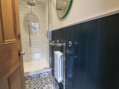 a bathroom with a shower with a radiator in it at Underfell in Ambleside