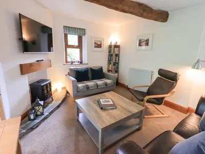 a living room with a couch and a table at Drystones in Grasmere
