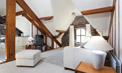 a living room with a white couch and a tv at High Raise in Grasmere