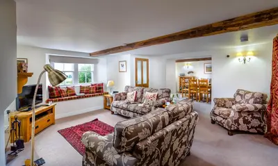 a living room with two couches and a tv at Low Longthwaite Farm in Watermillock