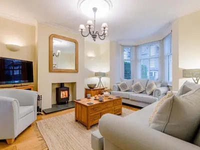 a living room with a couch and a fireplace at Oak House in Keswick