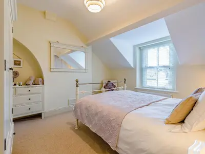 a bedroom with a bed and a window at Oak House in Keswick