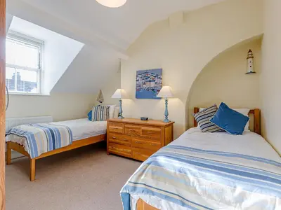 a bedroom with two twin beds and a window at Oak House in Keswick