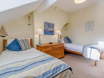 a bedroom with two beds and two lamps in it at Oak House in Keswick