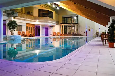 a large swimming pool in a large house at Rawfell in Ambleside
