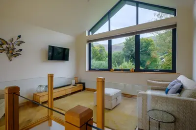a living room with a large window and a couch at The Old Police House in Grasmere