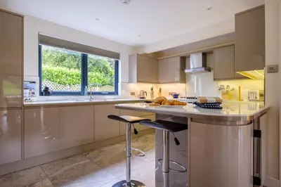 a kitchen with stainless steel appliances and a large window at The Old Police House in Grasmere
