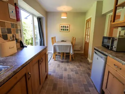 a kitchen with a table and a kitchen with a counter top at Bleaberry Cottage in Penrith