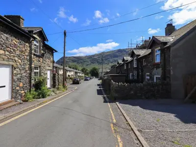 an empty street in a village with houses at Bleaberry Cottage in Penrith
