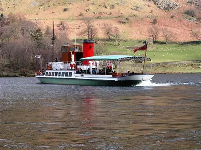 a boat on the water with people on it at Bleaberry Cottage in Penrith