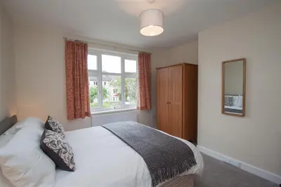 a bedroom with a bed and a window at Fell End in Keswick