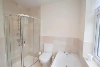 a bathroom with a shower and a toilet and a tub at Fell End in Keswick