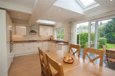 a kitchen with a table with a bowl of fruit on it at Fell End in Keswick
