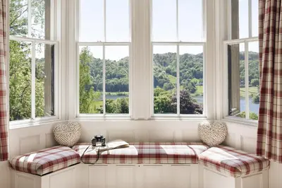 a window seat with two chairs and a book at Wetherlam in Ambleside