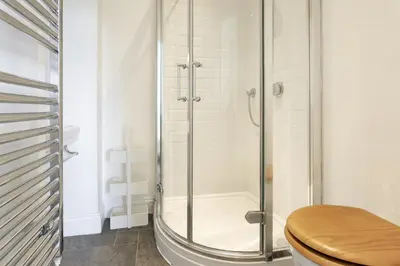 a bathroom with a glass shower with a toilet at Wetherlam in Ambleside