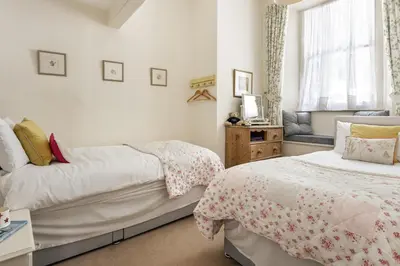 a bedroom with two beds and a window at Wetherlam in Ambleside