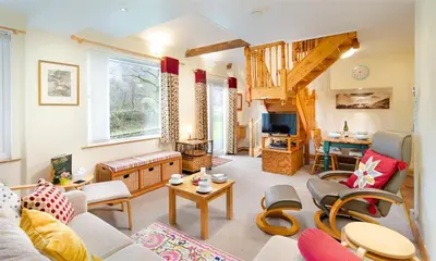 a living room with a couch and a table at Lingmoor View in Ambleside