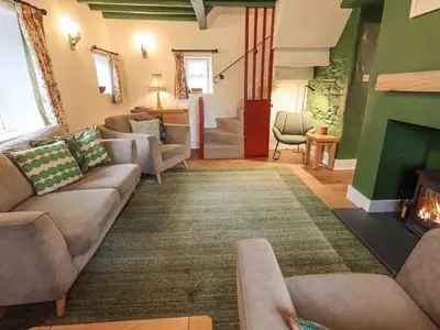 a living room with a couch and a fireplace at North Lodge in Grasmere