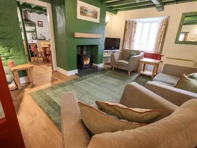 a living room with a couch and a fireplace at North Lodge in Grasmere
