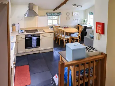a kitchen with a table and a dining room at Beckside Studio in Patterdale