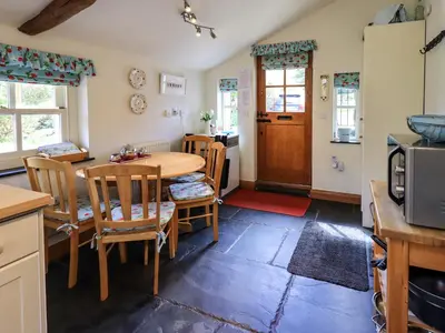 a kitchen and dining room with a table and chairs at Beckside Studio in Patterdale