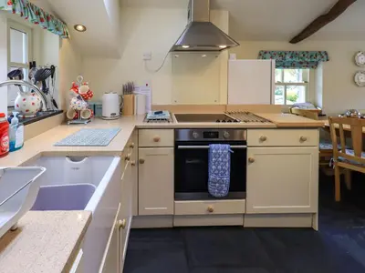 a kitchen with a stove and a sink at Beckside Studio in Patterdale