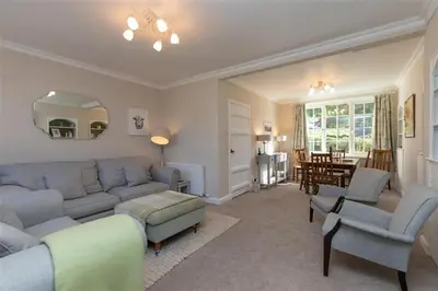 a living room with a couch and chairs and a table at Crozier Cottage in Ambleside