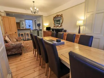 a dining room with a wooden table and chairs at Fairy Glen in Ambleside