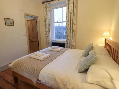 a bedroom with a bed with two towels on it at Fairy Glen in Ambleside