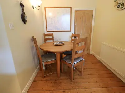 a wooden table and chairs in a room at Daisy Cottage in Grasmere