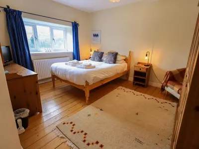 a bedroom with a bed and a window at Daisy Cottage in Grasmere