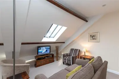 a living room with a couch and a tv at The Gallery in Grasmere