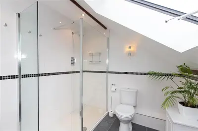 a bathroom with a toilet and a glass shower at The Gallery in Grasmere