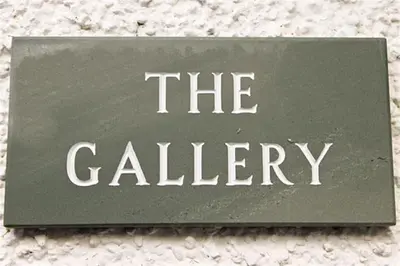 a sign that says the gallery on a wall at The Gallery in Grasmere