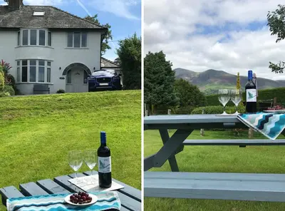 a picnic table with wine bottles and glasses on it at Riggside in Keswick