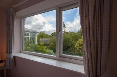 a window in a room with a view of trees at Brimbles in Keswick